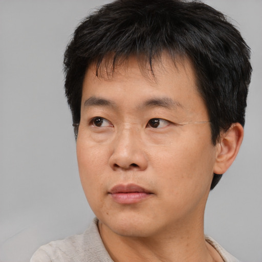 Neutral asian young-adult male with short  black hair and brown eyes
