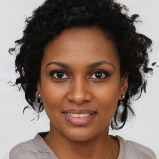 Joyful black young-adult female with medium  black hair and brown eyes