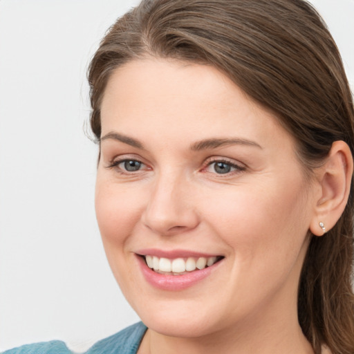 Joyful white young-adult female with medium  brown hair and grey eyes