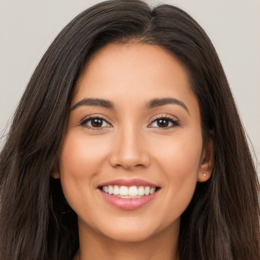 Joyful white young-adult female with long  brown hair and brown eyes