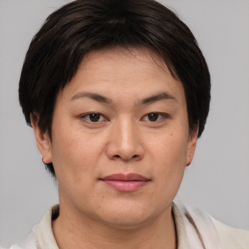 Joyful asian young-adult female with short  brown hair and brown eyes