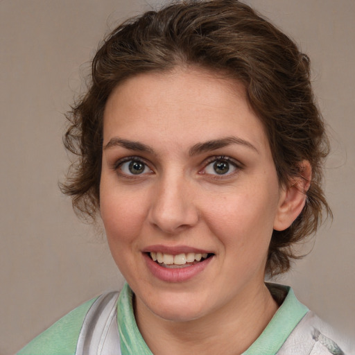 Joyful white young-adult female with medium  brown hair and blue eyes