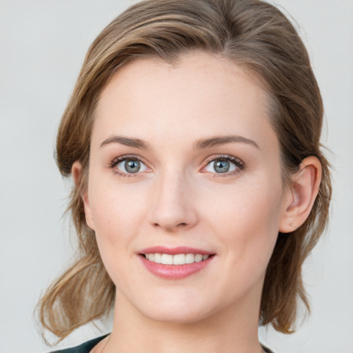 Joyful white young-adult female with medium  brown hair and blue eyes