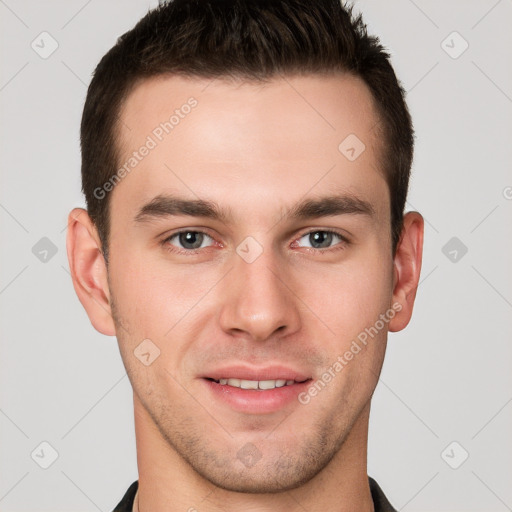 Joyful white young-adult male with short  brown hair and grey eyes