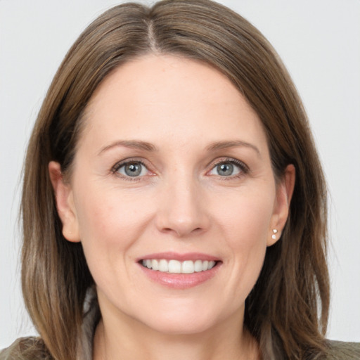 Joyful white young-adult female with long  brown hair and grey eyes