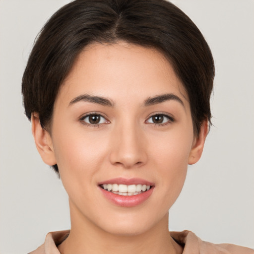 Joyful white young-adult female with short  brown hair and brown eyes