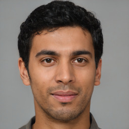 Joyful latino young-adult male with short  brown hair and brown eyes