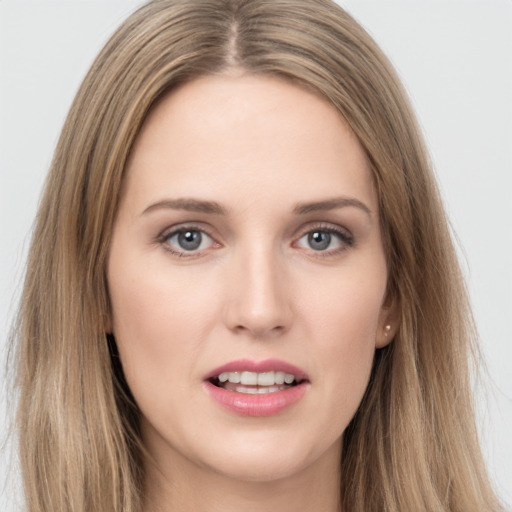 Joyful white young-adult female with long  brown hair and grey eyes