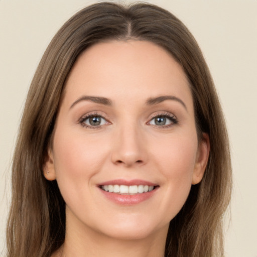 Joyful white young-adult female with long  brown hair and brown eyes