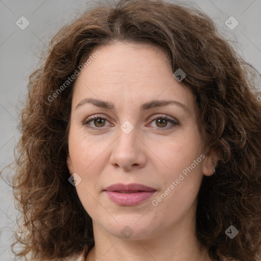 Joyful white adult female with long  brown hair and brown eyes