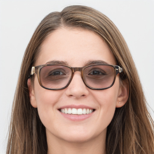 Joyful white young-adult female with long  brown hair and blue eyes