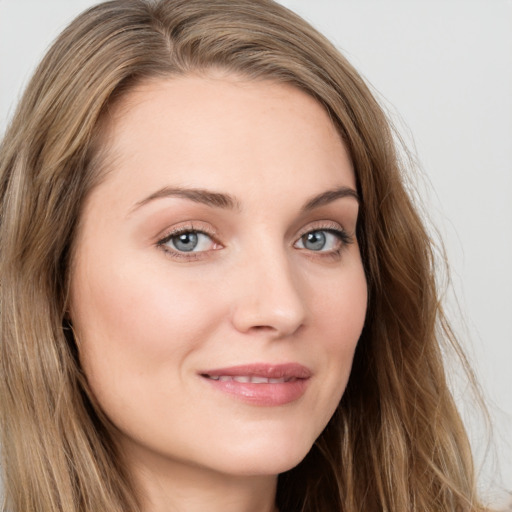 Joyful white young-adult female with long  brown hair and green eyes