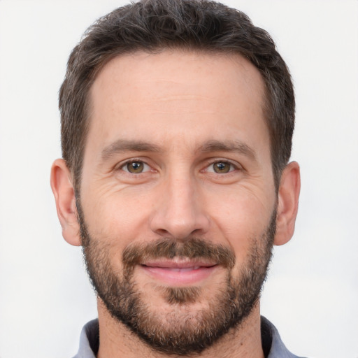 Joyful white adult male with short  brown hair and brown eyes