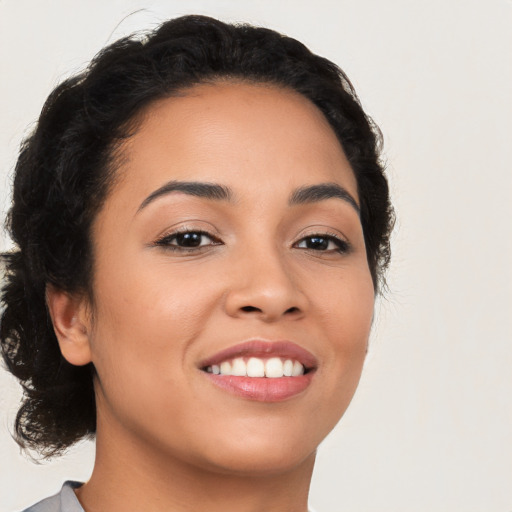 Joyful latino young-adult female with medium  black hair and brown eyes