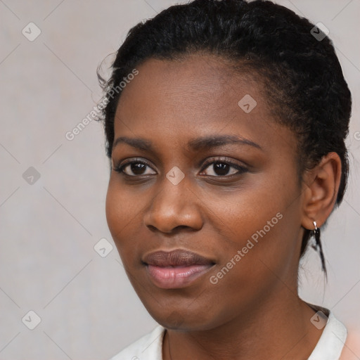 Joyful black young-adult female with short  black hair and brown eyes