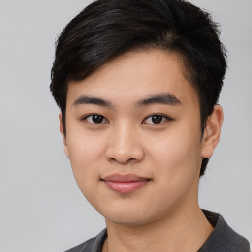 Joyful asian young-adult male with short  black hair and brown eyes