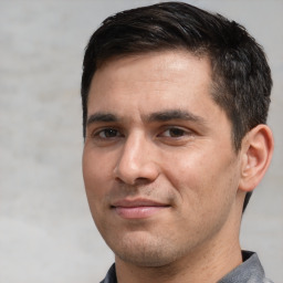 Joyful white adult male with short  brown hair and brown eyes