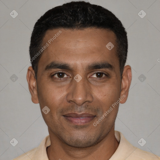 Joyful latino young-adult male with short  black hair and brown eyes