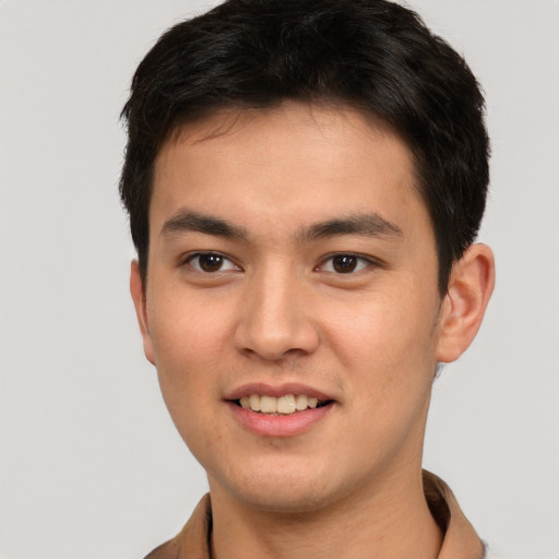 Joyful asian young-adult male with short  brown hair and brown eyes