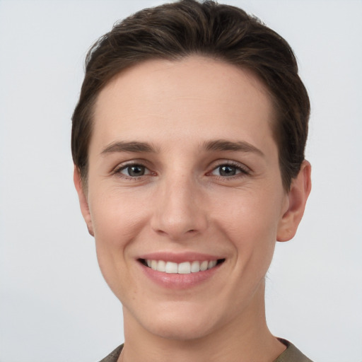 Joyful white young-adult female with short  brown hair and grey eyes