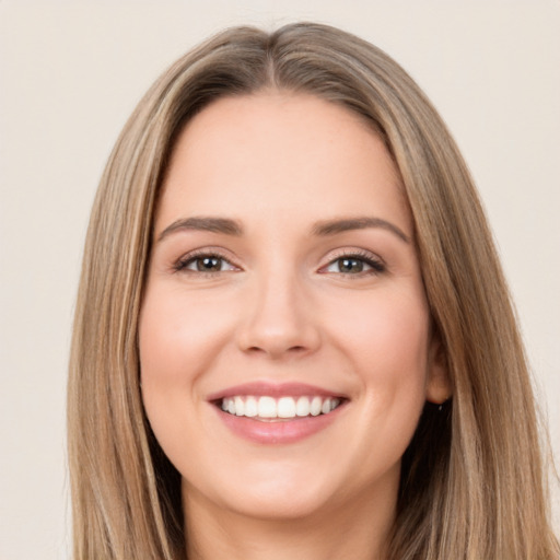 Joyful white young-adult female with long  brown hair and brown eyes