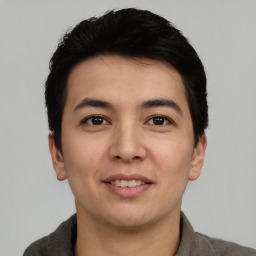 Joyful asian young-adult male with short  black hair and brown eyes