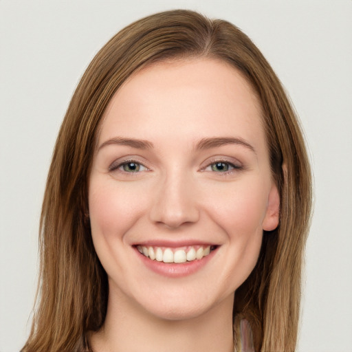 Joyful white young-adult female with long  brown hair and green eyes