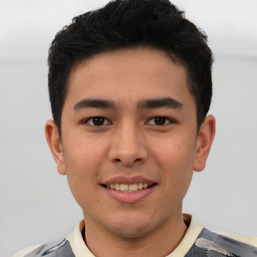 Joyful asian young-adult male with short  brown hair and brown eyes