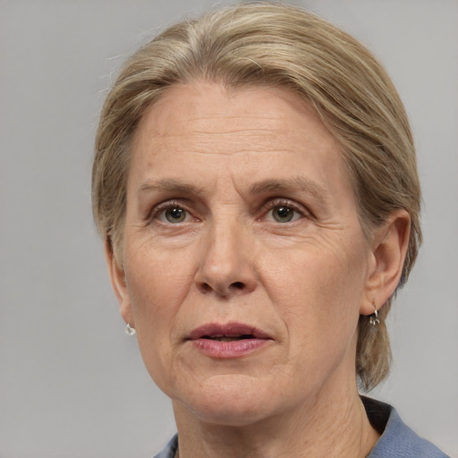 Joyful white middle-aged female with medium  brown hair and grey eyes