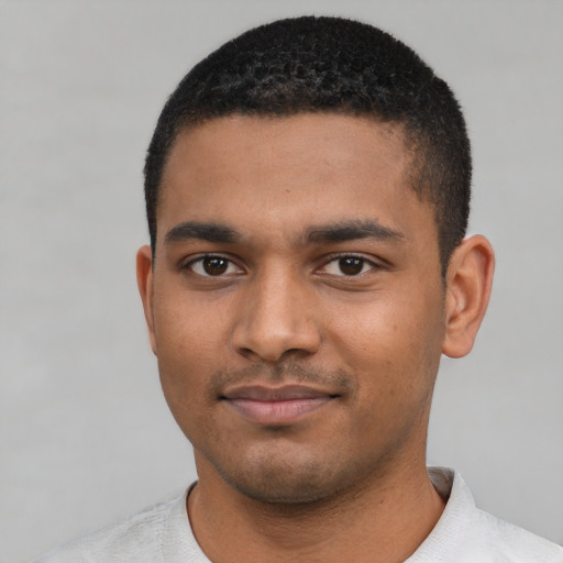 Joyful black young-adult male with short  black hair and brown eyes