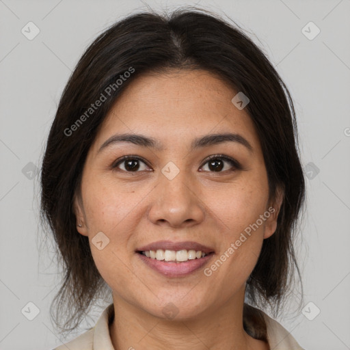 Joyful latino young-adult female with medium  brown hair and brown eyes