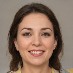 Joyful white young-adult female with medium  brown hair and brown eyes