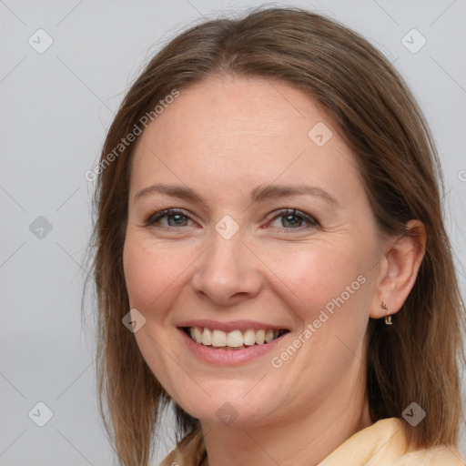 Joyful white adult female with medium  brown hair and grey eyes