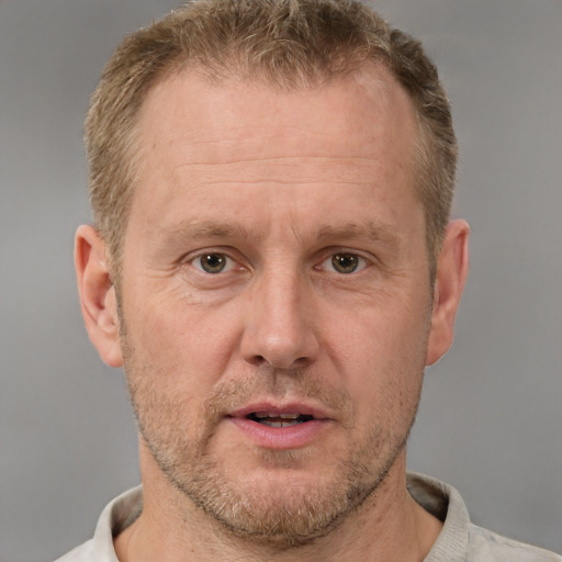 Joyful white middle-aged male with short  brown hair and brown eyes