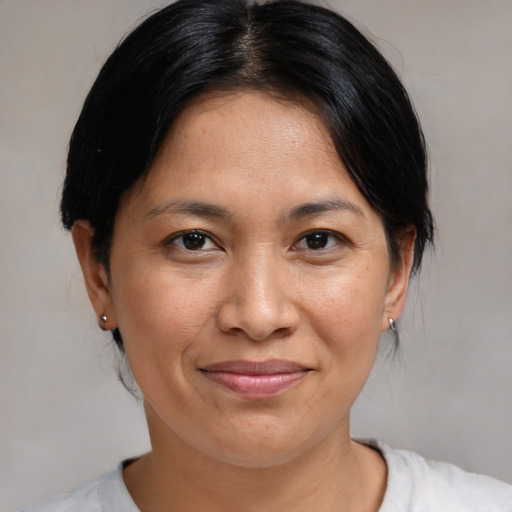 Joyful asian adult female with medium  brown hair and brown eyes