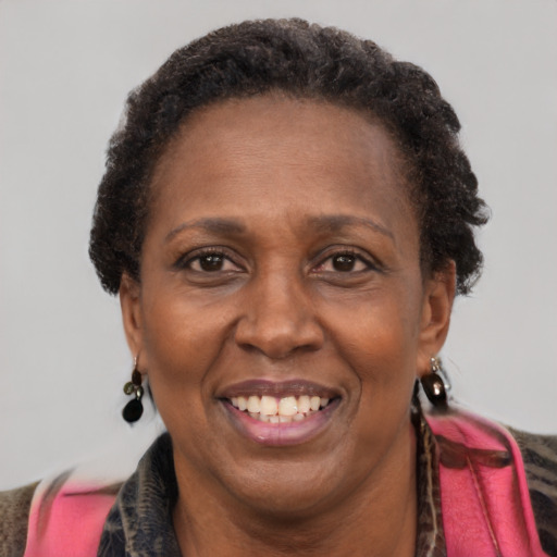 Joyful black adult female with medium  brown hair and brown eyes