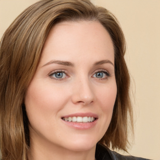 Joyful white young-adult female with long  brown hair and green eyes