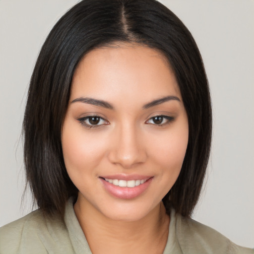 Joyful latino young-adult female with medium  brown hair and brown eyes