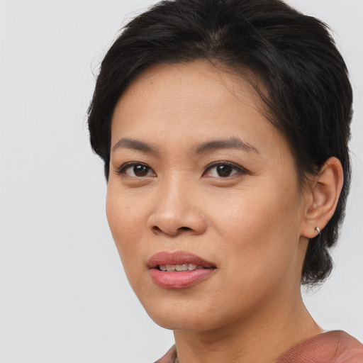 Joyful asian young-adult female with medium  brown hair and brown eyes