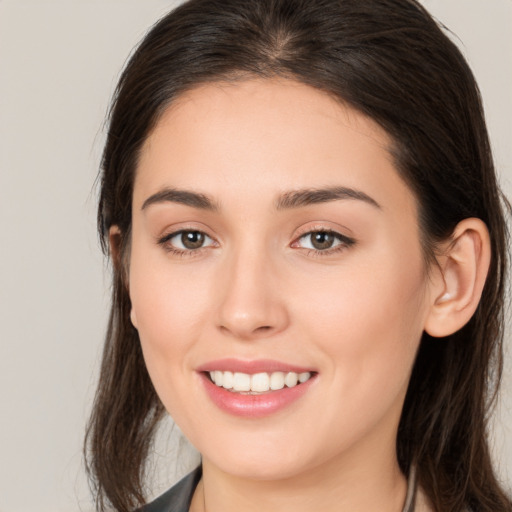 Joyful white young-adult female with long  brown hair and brown eyes