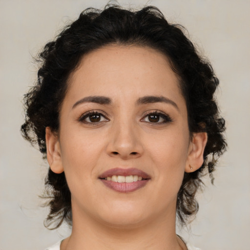 Joyful latino young-adult female with medium  brown hair and brown eyes