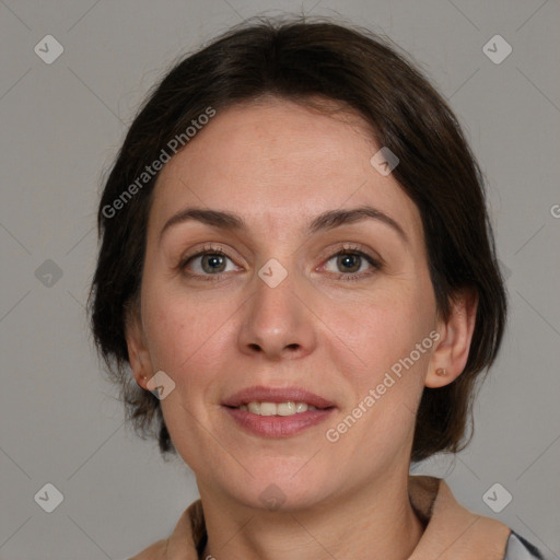 Joyful white adult female with medium  brown hair and grey eyes