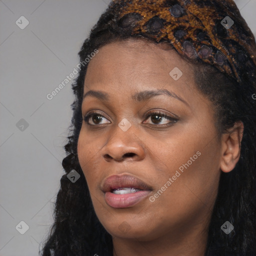 Joyful black young-adult female with long  black hair and brown eyes