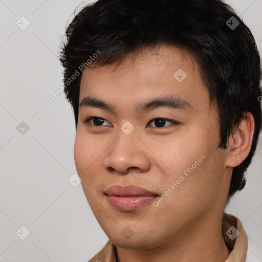 Joyful asian young-adult male with short  brown hair and brown eyes