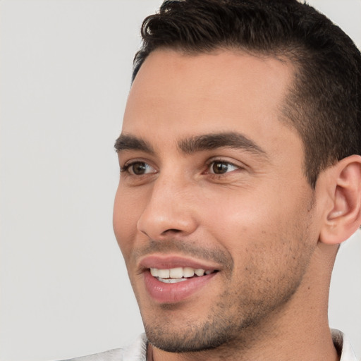 Joyful white young-adult male with short  brown hair and brown eyes