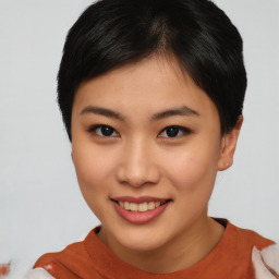 Joyful asian young-adult female with short  black hair and brown eyes