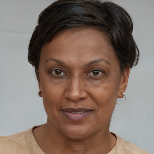 Joyful black adult female with short  brown hair and brown eyes