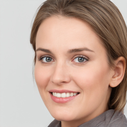 Joyful white young-adult female with medium  brown hair and grey eyes