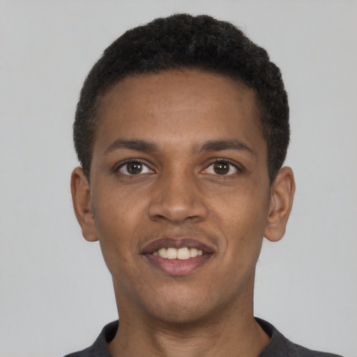 Joyful black young-adult male with short  black hair and brown eyes