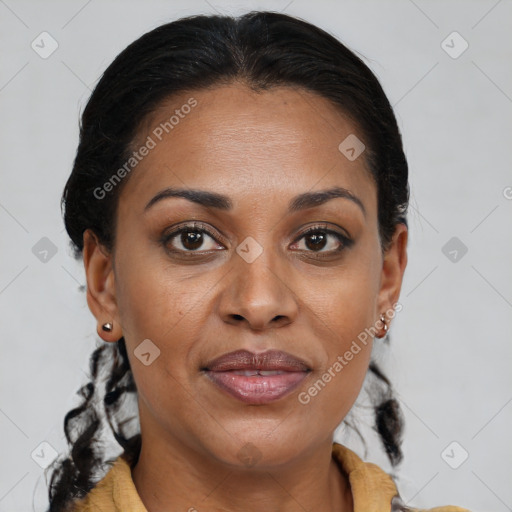 Joyful black adult female with medium  brown hair and brown eyes